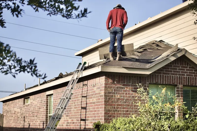Professional roofer working on a residential roof in Pecan Valley